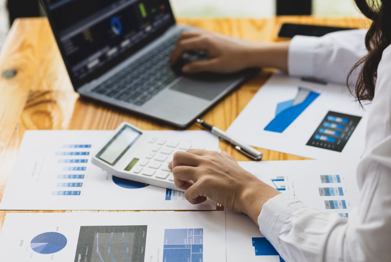 Imagen de persona sacando cuentas en un escritorio Imagen de persona sacando cuentas en un escritorio